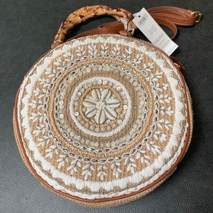 Round woven handbag adorned with shells, white stitching and silver beads. NWT